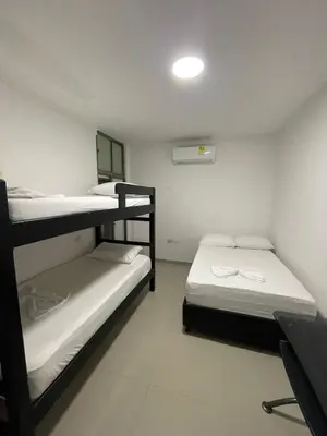 a room with two bunk beds in it at Cabañas Melany in Coveñas