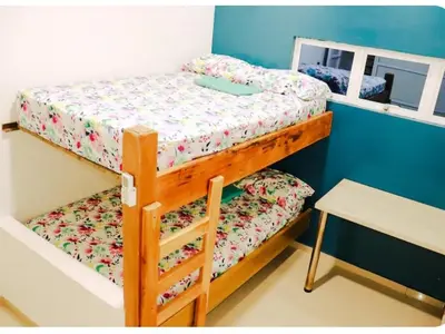 a bedroom with two bunk beds and a table at Casa con Piscina Privada Playas del Mar in Cartagena de Indias