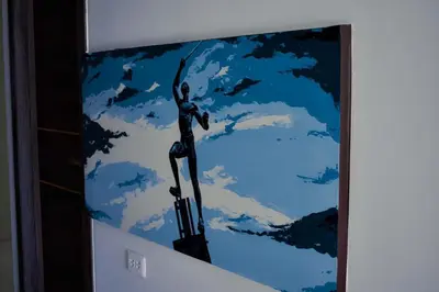 a painting of a man on a wall with clouds at Cienaguas Hotel in Ciénaga