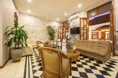 a living room with a couch and a table and chairs at San Pedro Claver Luxury in the walled city in Cartagena de Indias