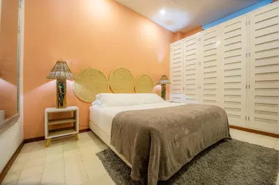 a bedroom with a bed and a mirror on the wall at San Pedro Claver Luxury in the walled city in Cartagena de Indias