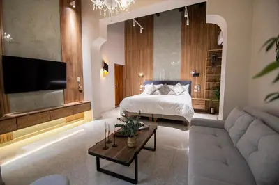 a bedroom with a bed and a couch and a tv at Scalea Di Mare Hotel in Cartagena de Indias