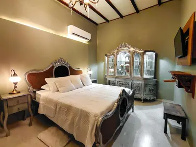 a bedroom with a bed and a dresser in a room at Scalea Di Mare Hotel in Cartagena de Indias