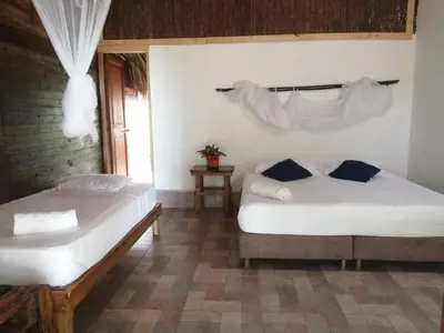 a bedroom with two beds and a window at Centro Ubuntu in Isla Grande