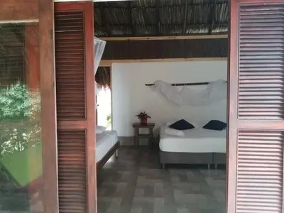a bedroom with two beds in a room at Centro Ubuntu in Isla Grande
