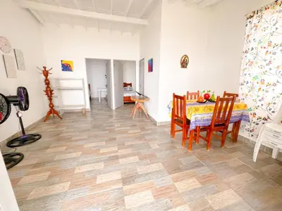 a dining room with a table and chairs in a room at Cabaña frente al mar Encanto del Viento in San Bernardo del Viento