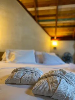 two towels sitting on top of a bed at ADA MARINA, hotel campestre con la mejor vista a Cartagena in Turbaco