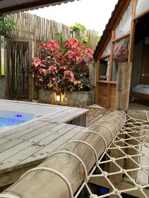 a rope laying next to a swimming pool with flowers at ADA MARINA, hotel campestre con la mejor vista a Cartagena in Turbaco