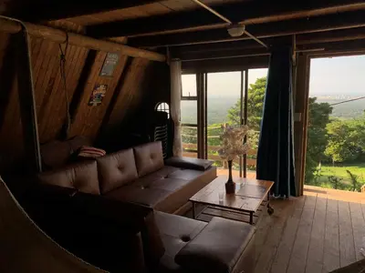 a living room with a couch and a table at ADA MARINA, hotel campestre con la mejor vista a Cartagena in Turbaco