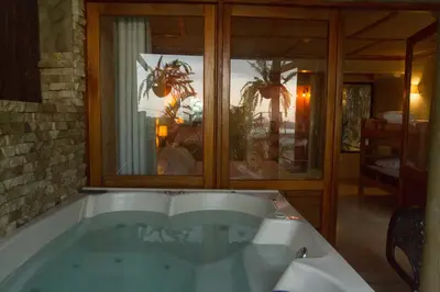 a bath tub in a room with a window at ADA MARINA, hotel campestre con la mejor vista a Cartagena in Turbaco