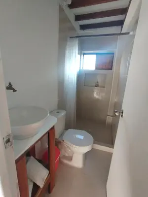 a bathroom with a sink and a toilet at Quatro palos in Rincón