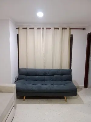 a blue couch sitting in a living room at Apartamento mar in Cartagena de Indias