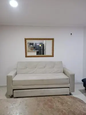 a couch in a living room with a mirror at Apartamento mar in Cartagena de Indias