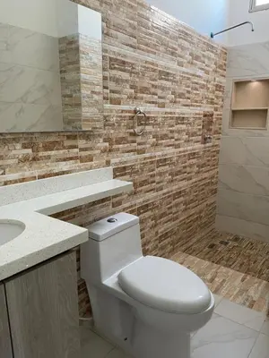 a bathroom with a white toilet and a sink at Murano Hotel in Coveñas