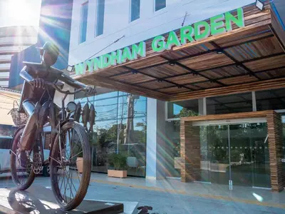 a statue of a woman on a bike in front of a building at Wyndham Garden Cartagena in Cartagena de Indias
