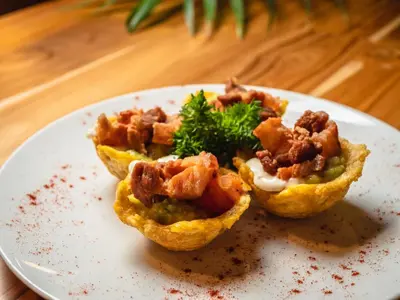 a plate of food with food in muffins on a table at Wyndham Garden Cartagena in Cartagena de Indias