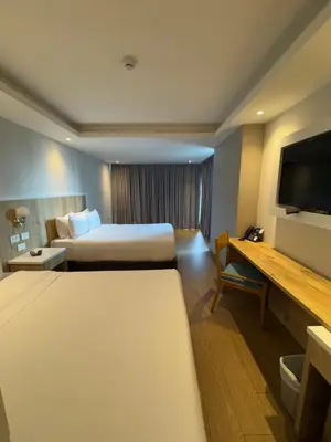 a hotel room with two beds and a flat screen tv at Wyndham Garden Cartagena in Cartagena de Indias