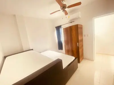 a bedroom with a bed and a ceiling fan at Mayo apartamentos in Santiago