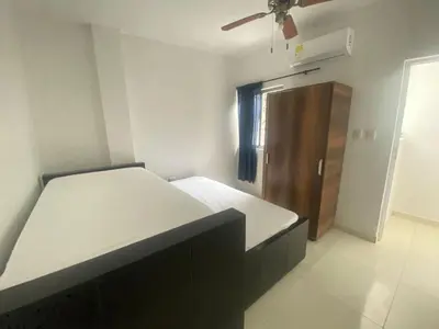 a bedroom with a bed and a wooden cabinet at Mayo apartamentos in Santiago