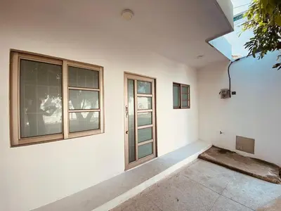 a white room with a door and windows at Mayo apartamentos in Santiago