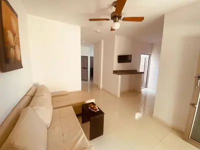 a living room with a couch and a ceiling fan at Mayo apartamentos in Santiago