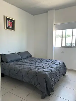 a bedroom with a bed in a white room at ARMANI in Puerto Colombia