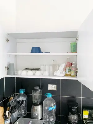 a kitchen with a counter with bottles and a blender at ARMANI in Puerto Colombia