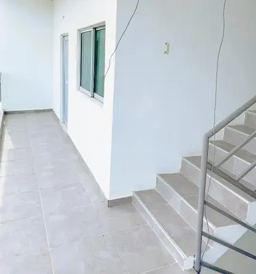 a staircase in a room with a white wall at ARMANI in Puerto Colombia