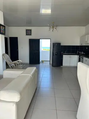 a living room with a couch and a kitchen at ARMANI in Puerto Colombia