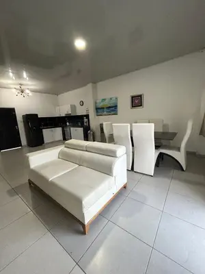 a living room with a couch and a table and chairs at ARMANI in Puerto Colombia