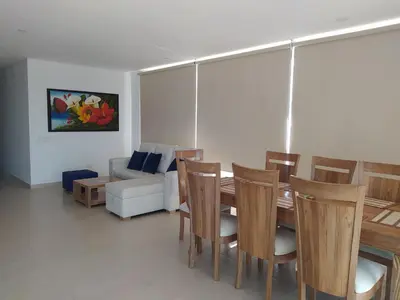 a dining room with a table and chairs and a couch at Cabaña Apartamento En Coveñas - Fontaine Bleu in Coveñas