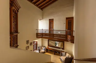 a living room with a fireplace and a balcony at Ananda Hotel Boutique in Cartagena de Indias