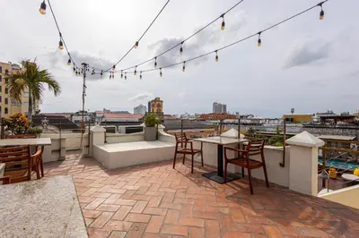 a patio with a table and chairs on a roof at Ananda Hotel Boutique in Cartagena de Indias