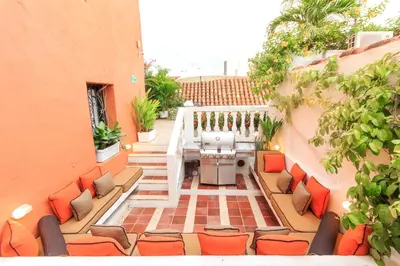 a patio with chairs and a table on a balcony at Hotel Boutique Casa del Coliseo in Cartagena de Indias