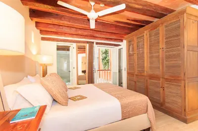 a bedroom with a bed and a ceiling fan at Hotel Boutique Casa del Coliseo in Cartagena de Indias