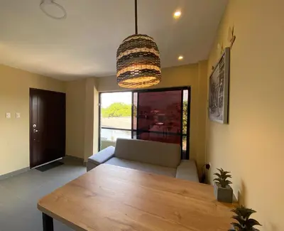 a living room with a table and a couch at Apartaestudios - Casa Tamarindo in Aracataca