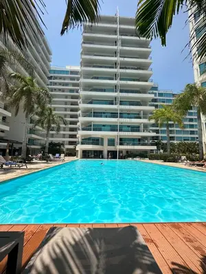 a swimming pool in front of a tall building at Playa -Boquilla -Apto en Condominio in Cartagena de Indias