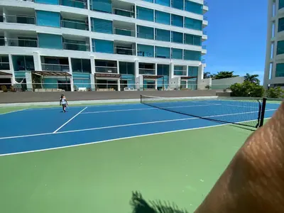 a person is playing tennis on a tennis court at Apto- Condominio H Sonesta - Morros-salida a la playa - cerca Hotel Americas in Cartagena de Indias