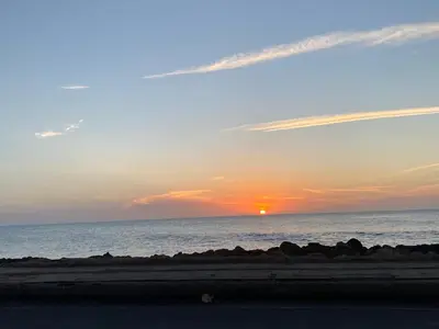 a sunset over the ocean with the sun setting at Apto- Condominio H Sonesta - Morros-salida a la playa - cerca Hotel Americas in Cartagena de Indias