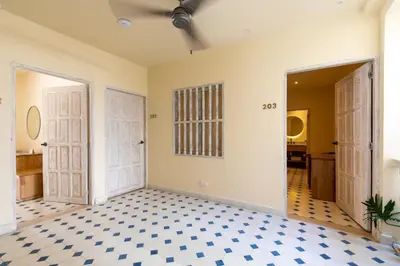 a room with two doors and a checkered floor at B Haus Hotel Boutique in Cartagena de Indias