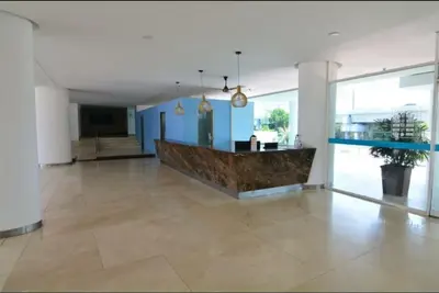 a large room with a lobby with blue walls at Cartagena Genius Morros frente al mar in Cartagena de Indias