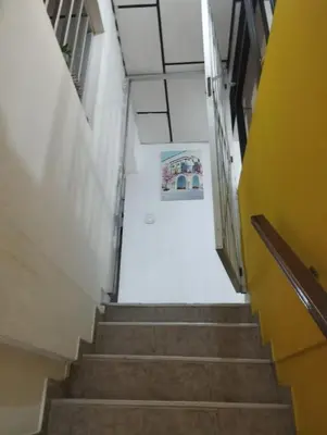 a stairway in a building with a picture on the wall at Apartamentos San Felipe in Cartagena de Indias