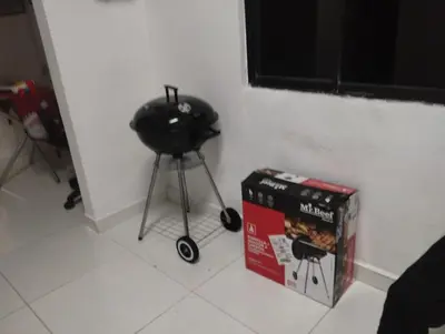 a black stool next to a box next to a wall at Apartamentos San Felipe in Cartagena de Indias