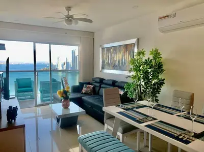 a living room with a couch and a table at 19TH FLOOR LUXURY APARTMENT BAY VIEW CARTAGENA in Cartagena de Indias