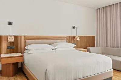 a bedroom with a large white bed and a chair at Barranquilla Marriott Hotel in Barranquilla