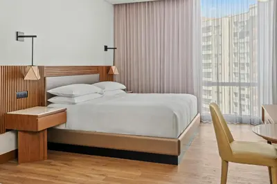 a bedroom with a bed and a desk and a chair at Barranquilla Marriott Hotel in Barranquilla