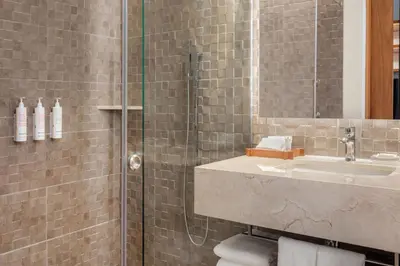a bathroom with a sink and a shower at Barranquilla Marriott Hotel in Barranquilla