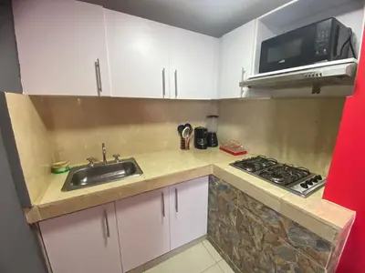 a small kitchen with a sink and a microwave at La casita de max y tim apartaestudio 4to piso in Cartagena de Indias