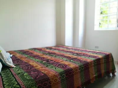 a colorful blanket sitting on a bed in a room at En mi casa cartagena in Cartagena de Indias