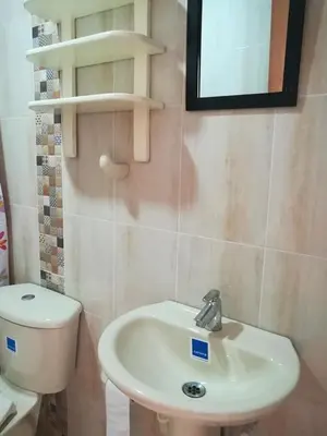 a bathroom with a white sink and a toilet at En mi casa cartagena in Cartagena de Indias